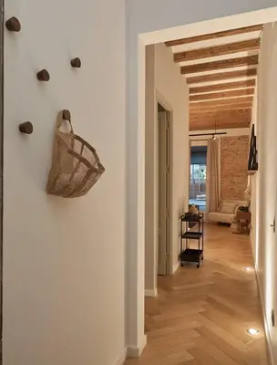 a room with a stool and shelves on the wall at Zuma - 1 bedroom and terrace in Eixample Esquerra in Barcelona