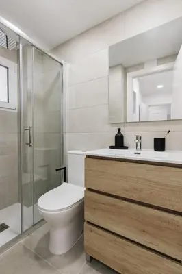 a small bedroom with a bed and a window at Itza - 3 bedrooms and office and terrace in Gràcia in Barcelona