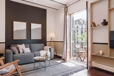 a living room with a couch and a table at Moumour - 2 bedrooms in Eixample Dreta in Barcelona