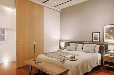 a bedroom with a large bed and a desk at Moumour - 2 bedrooms in Eixample Dreta in Barcelona
