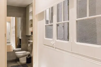 a bedroom with a large bed and a mirror at Moumour - 2 bedrooms in Eixample Dreta in Barcelona