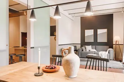 a bedroom with a large bed and a wooden table at Moumour - 2 bedrooms in Eixample Dreta in Barcelona