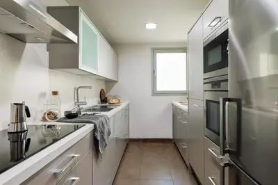 a living room with a couch and a tv at Emporda - 2 bedrooms in Eixample Esquerra in Barcelona