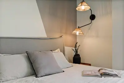 a bedroom with a bed with a book on it at Emporda - 2 bedrooms in Eixample Esquerra in Barcelona