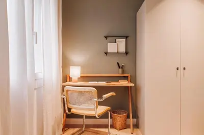 a bathroom with a table and a toilet in a room at Casares - 1 bedroom in Gràcia in Barcelona