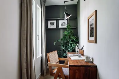 a table and chairs on a balcony with a coffee cup at Campro - 3 bedrooms w/ balcony in Eixample Esquerra in Barcelona