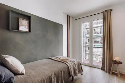 a dining room with a wooden table and chairs at Campro - 3 bedrooms w/ balcony in Eixample Esquerra in Barcelona