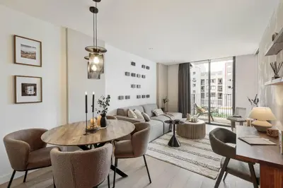 a desk with a television and a chair in a room at Lys - 2 bedrooms and pool in Eixample Esquerra in Barcelona