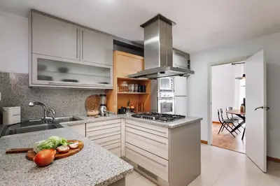 a dining room with a wooden table and chairs at Munia - 3 bedrooms and office in Sant Gervasi in Barcelona