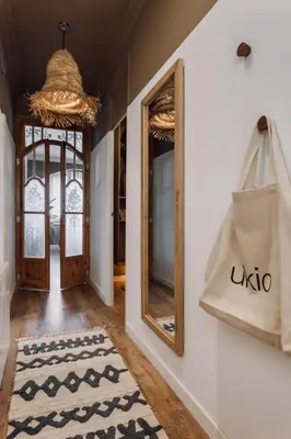 a hallway with mirrors and a rug on a wall at Kalo - 1 bedroom and office in Eixample Esquerra in Barcelona