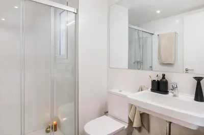 a bedroom with a large bed and white cabinets at Cerler - 2 bedrooms and terrace in Sant Antoni in Barcelona