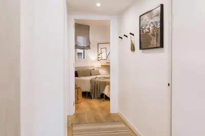 a kitchen and dining room with a wooden table at Cerler - 2 bedrooms and terrace in Sant Antoni in Barcelona