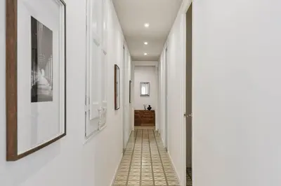 a living room with a couch and a tv at Oltre - 3 bedrooms in Eixample Esquerra in Barcelona