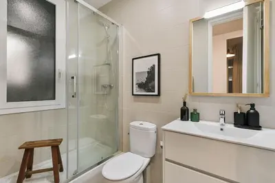 a white kitchen with a stove and a sink at Oltre - 3 bedrooms in Eixample Esquerra in Barcelona