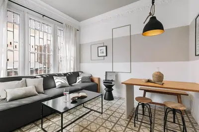 a living room with a couch and a table at Oltre - 3 bedrooms in Eixample Esquerra in Barcelona