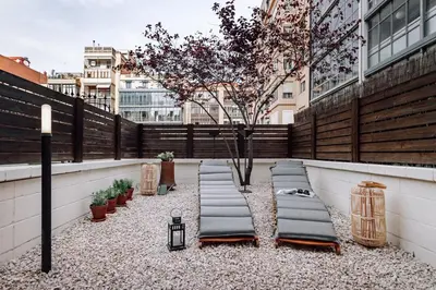 a living room with a couch and a table at Huelma - 1 bedroom and terrace in Eixample Dreta in Barcelona