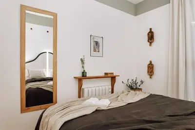 a bedroom with a large mirror and a bed at Huelma - 1 bedroom and terrace in Eixample Dreta in Barcelona