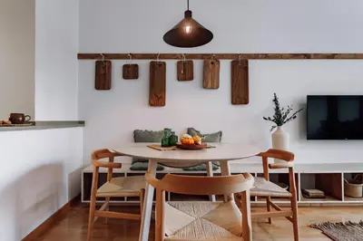 a rooftop patio with chairs and a couch and tables at Huelma - 1 bedroom and terrace in Eixample Dreta in Barcelona