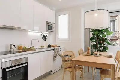a bedroom with a bed with a white wall at Ona - 2 bedrooms in Sant Gervasi in Barcelona
