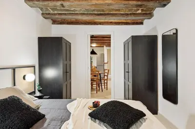 a kitchen with a wooden ceiling and a table and chairs at Sitges - 2 bedrooms in St Pere Sta Caterina i Ribera in Barcelona