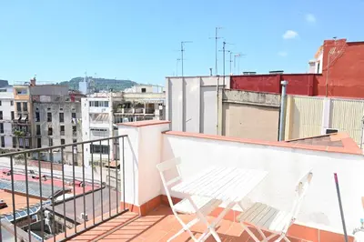 a white chair sitting on top of a balcony at Homenfun Barcelona Ciutat Vella in Barcelona