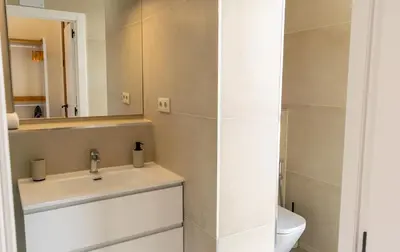 a bathroom with a sink and a mirror and a toilet at 