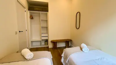 two beds in a room with a closet at 