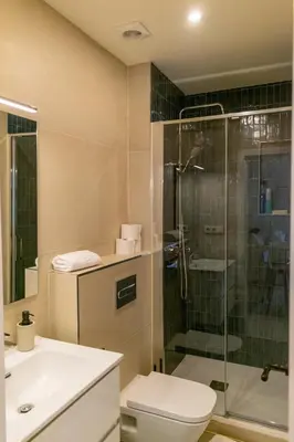 a bathroom with a shower and a toilet and a sink at 
