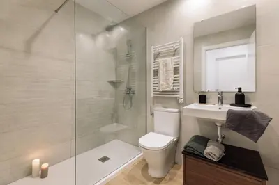 a living room with white doors and a couch at Tilapa - 2 bedrooms and terrace in Sant Antoni in Barcelona