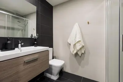 a kitchen with black counters and a sink at Hebron - 2 bedrooms and office in Gràcia in Barcelona