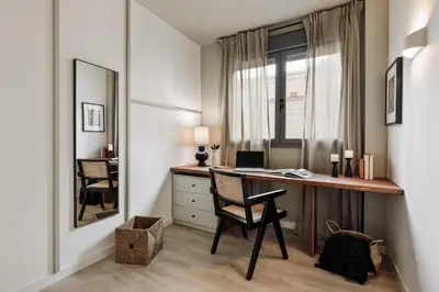 a black table and two chairs on a balcony at Hebron - 2 bedrooms and office in Gràcia in Barcelona