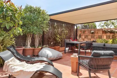 a living room with a couch and a table at Torla - 3 bedrooms and terrace in Sant Gervasi in Barcelona