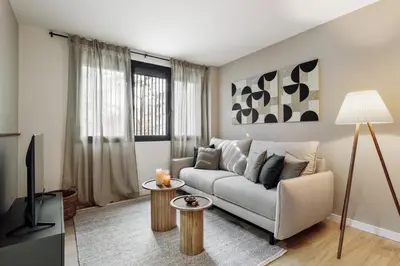 a living room with a couch and a table at Paul - 2 bedrooms and pool in Poblenou in Barcelona