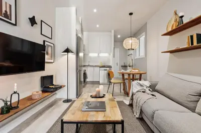 a bedroom with white cabinets and a bed at Acconci - Studio and terrace in Eixample Esquerra in Barcelona