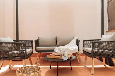 a kitchen with a table and a stainless steel refrigerator at Acconci - Studio and terrace in Eixample Esquerra in Barcelona