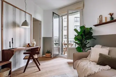 a living room with a television and a table at Montoro - 1 bedroom in Eixample Esquerra in Barcelona