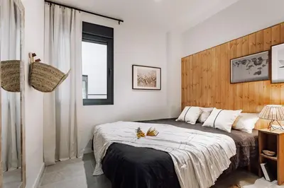 a bedroom with a large bed and a window at Aldeire - 2 bedrooms, office in Eixample Esquerra in Barcelona