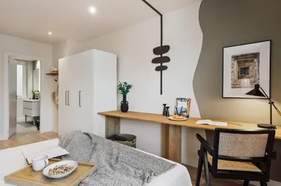 a small bedroom with a bed and a mirror at Chulamar - 2 bedrooms and balcony in Sant Gervasi in Barcelona
