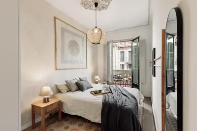 a bedroom with a large bed with a wooden headboard at Lluna - 2 Bedrooms and office in Gracia in Barcelona
