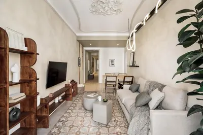 a living room with a table and a couch at Lluna - 2 Bedrooms and office in Gracia in Barcelona