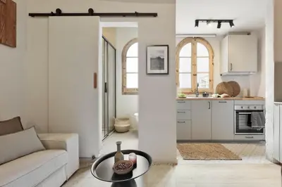 a bedroom with a large bed with a wooden headboard at Aleu - 2 bedrooms and balcony in Sagrada Família in Barcelona