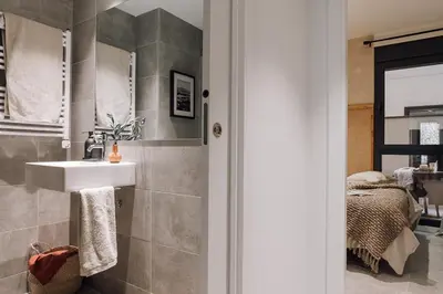 a living room with a table and a kitchen at Nivar - 2 bedrooms in Eixample Esquerra in Barcelona