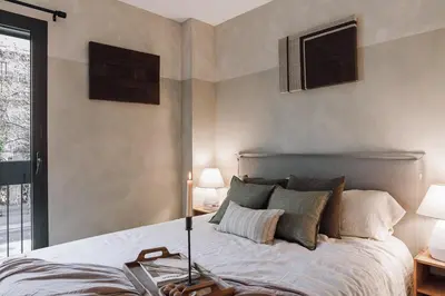 a bedroom with a bed with two lamps and a window at Nivar - 2 bedrooms in Eixample Esquerra in Barcelona