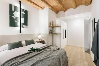 a bedroom with a bed and two night stands at Cadaques - 1 bedroom and balcony in Sant Antoni in Barcelona
