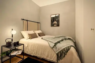 a kitchen with white cabinets and a black counter top at Akita - 2 bedrooms, terrace in Eixample Esquerra in Barcelona
