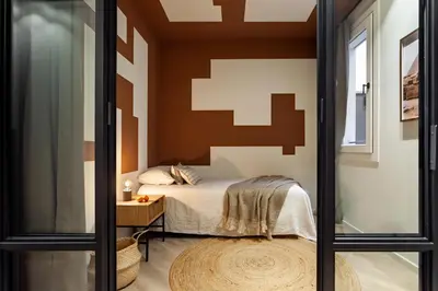 a room with a desk with a chair and a candle at Siwa - 2 bedrooms in Eixample Dreta in Barcelona