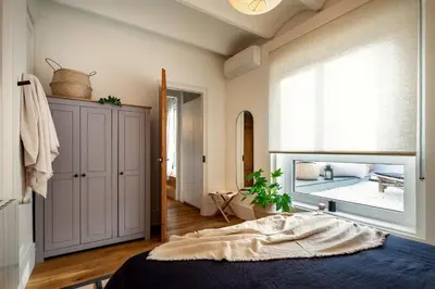 a desk with a computer and a printer and a chair at Fuji - 2 bedrooms and terrace in Eixample Esquerra in Barcelona
