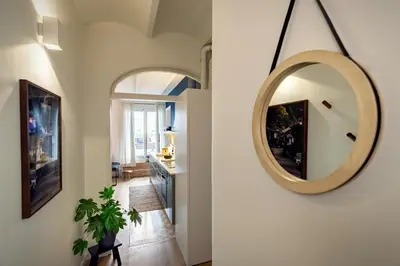 a living room with a couch and a desk at Fuji - 2 bedrooms and terrace in Eixample Esquerra in Barcelona