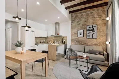 a living room with a couch and a table at Espriu - 2 bedrooms and balcony in Sant Antoni in Barcelona