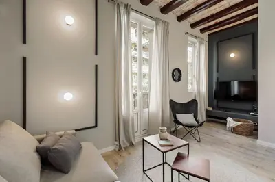 a living room with a couch and a brick wall at Espriu - 2 bedrooms and balcony in Sant Antoni in Barcelona